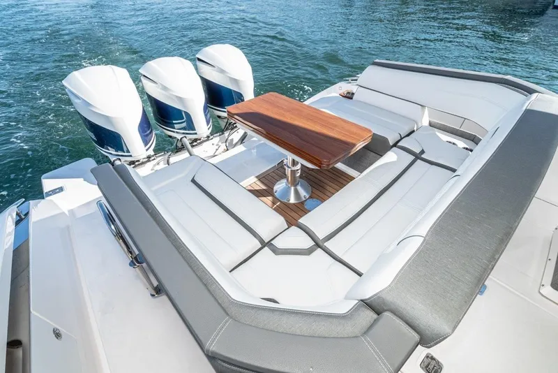 Slide: The Image of 2019 Tiara Yachts 38 LS with luxurious seating area and triple engines. - 43