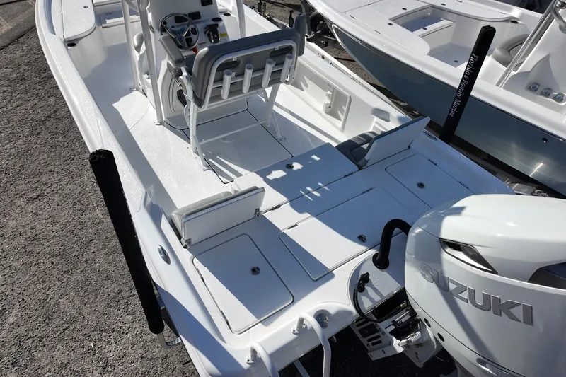 Slide: The Image of 2026 Blazer PureBay 2400 boat with Suzuki engine, featuring spacious deck and seating. - 4