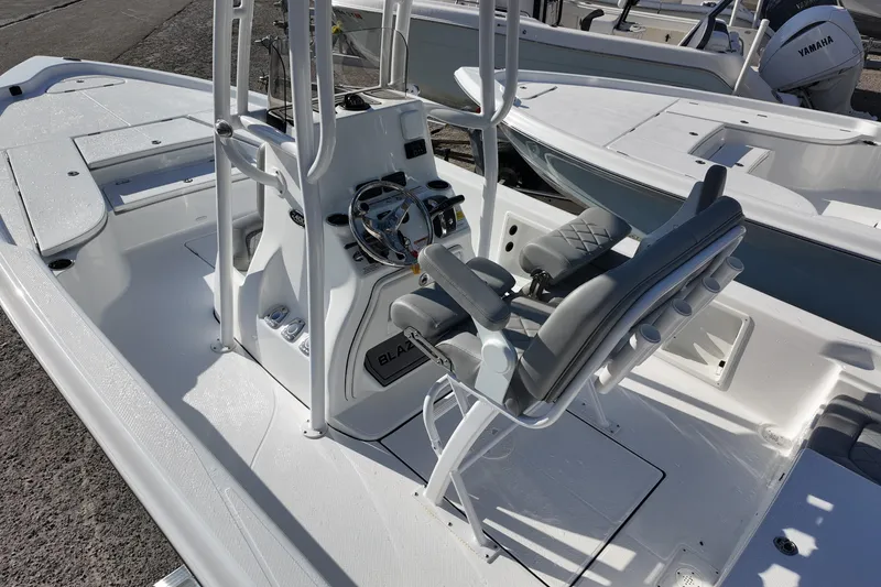 Slide: The Image of 2026 Blazer PureBay 2400 boat interior with steering console and seating. - 5