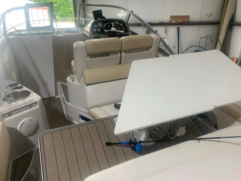 Slide: The Image of 2008 Four Winns V258 boat interior with seating, table, and helm. - 16