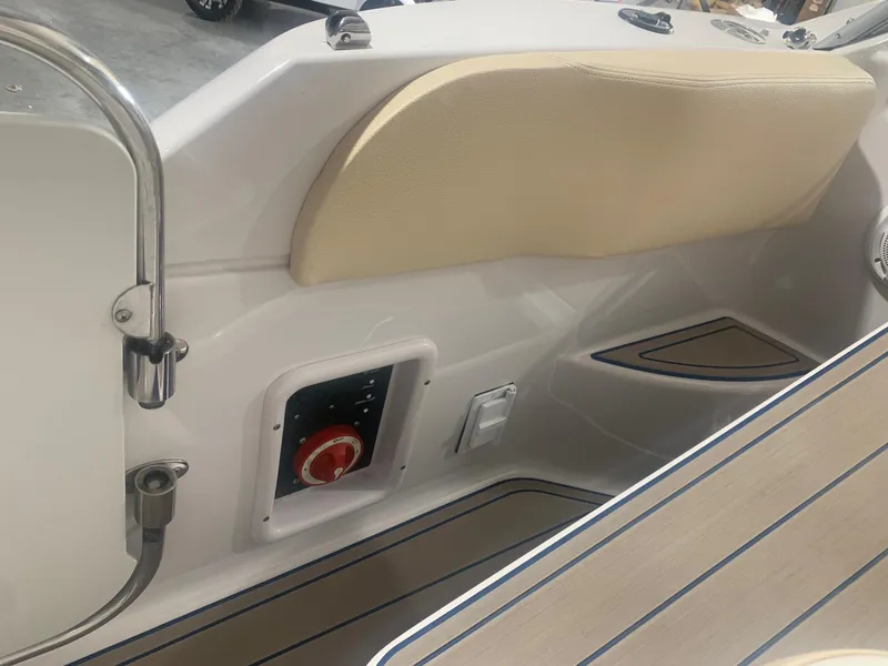 Slide: The Image of Interior view of a 2008 Four Winns V258 boat, featuring beige seating and control panel. - 17
