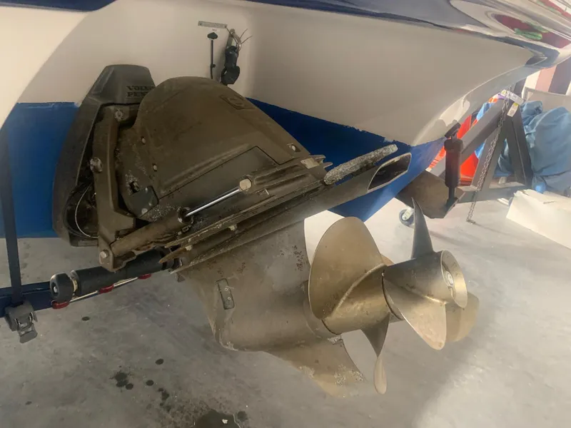 Slide: The Image of 2008 Four Winns V258 boat propeller and stern drive in a garage setting. - 22