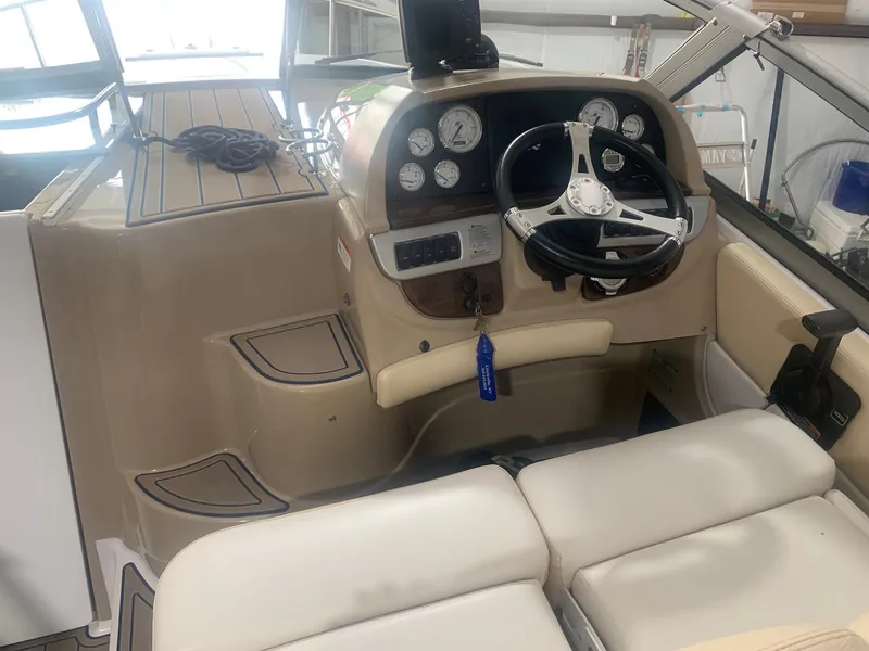 Slide: The Image of 2008 Four Winns V258 boat cockpit with steering wheel and instrument panel. - 25