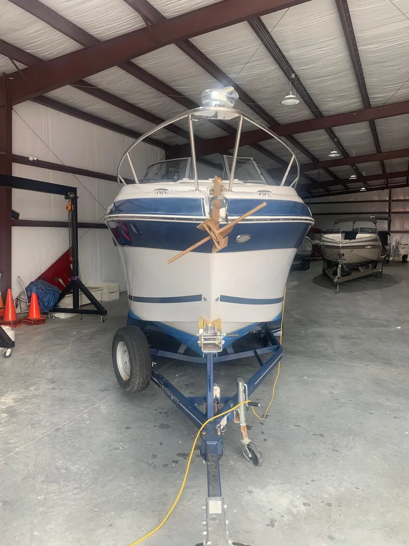 Slide: The Image of 2008 Four Winns V258 boat on trailer in indoor storage facility. - 3