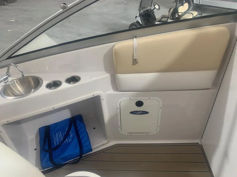 Slide: The Image of 2008 Four Winns V258 boat interior with sink, cup holders, and storage compartment. - 30