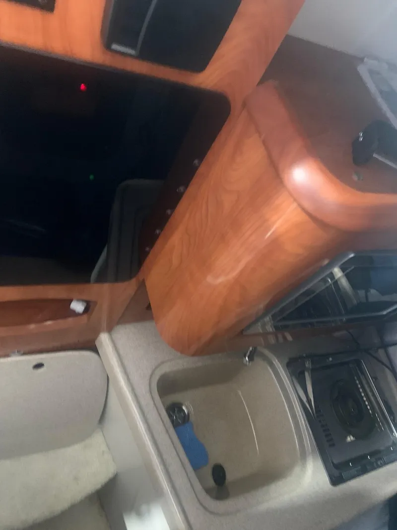 Slide: The Image of Interior of 2008 Four Winns V258 boat with kitchenette and wood finish. - 31
