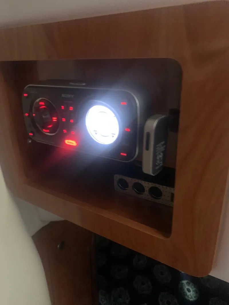 Slide: The Image of 2008 Four Winns V258 boat stereo system with illuminated controls in wooden panel. - 33