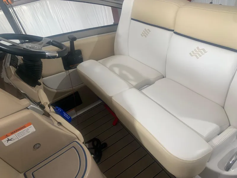 Slide: The Image of 2008 Four Winns V258 boat interior with white seating and steering wheel. - 36