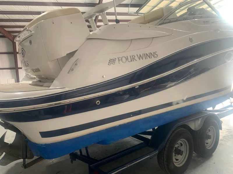 Slide: The Image of 2008 Four Winns V258 boat on trailer in indoor storage. - 38