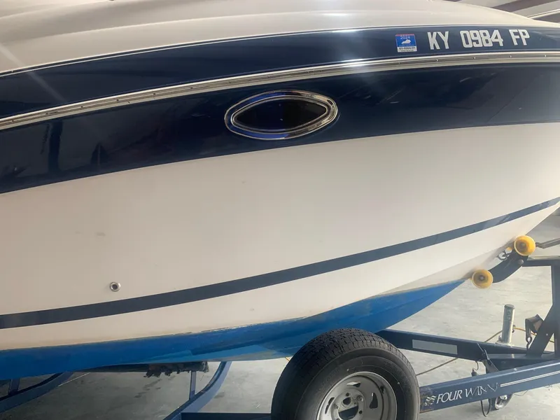 Slide: The Image of 2008 Four Winns V258 boat on trailer, side view with registration number visible. - 39