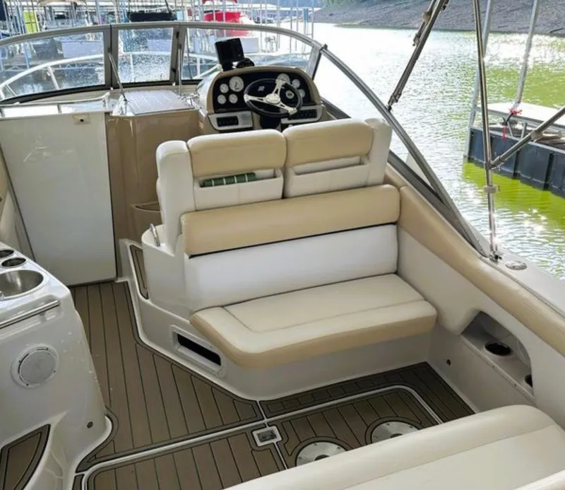 Slide: The Image of 2008 Four Winns V258 boat interior with beige seating and steering console. - 6