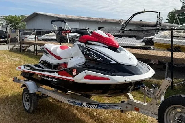The Image of 2021 Yamaha WaveRunner VX Deluxe on trailer, parked outdoors near boats. - 0