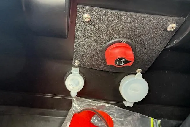 Slide: The Image of Control panel of a 2021 Yamaha WaveRunner VX Deluxe with red safety switch and connectors. - 12