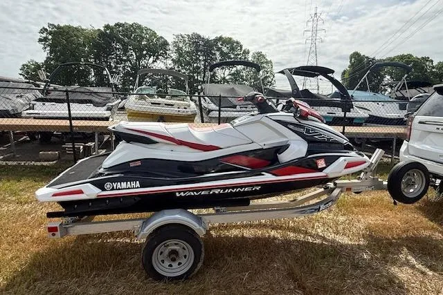 Slide: The Image of 2021 Yamaha WaveRunner VX Deluxe on trailer, parked outdoors near boats. - 2