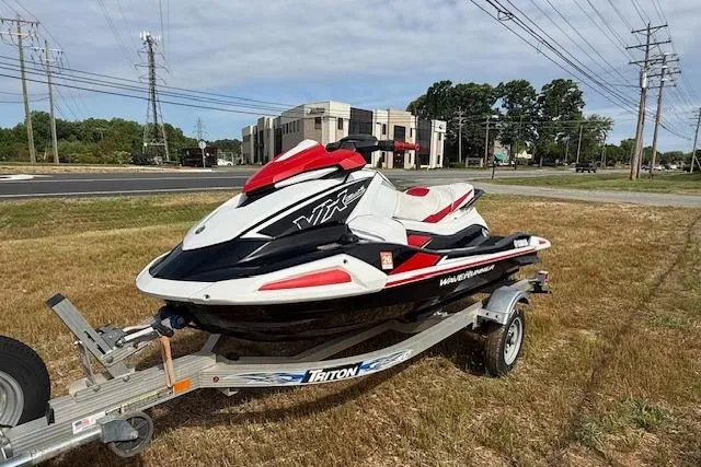 Slide: The Image of 2021 Yamaha WaveRunner VX Deluxe on Triton trailer, parked on grass near road and buildings. - 7