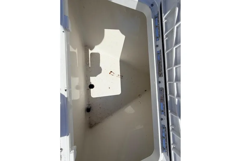 Slide: The Image of Open storage compartment of 2022 Parker 1801 Center Console boat, showing interior details. - 13