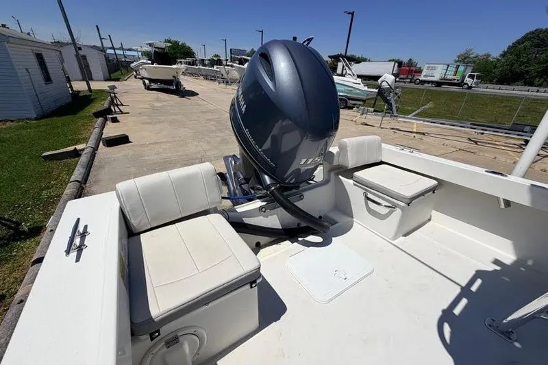 Slide: The Image of 2022 Parker 1801 Center Console boat with Yamaha outboard motor, docked outdoors. - 15
