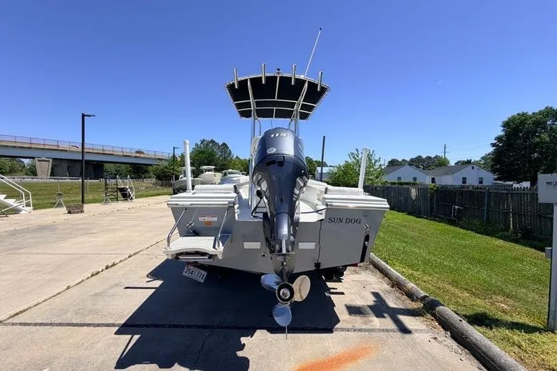 Slide: The Image of 2022 Parker 1801 Center Console boat on trailer, parked outdoors under clear blue sky. - 3