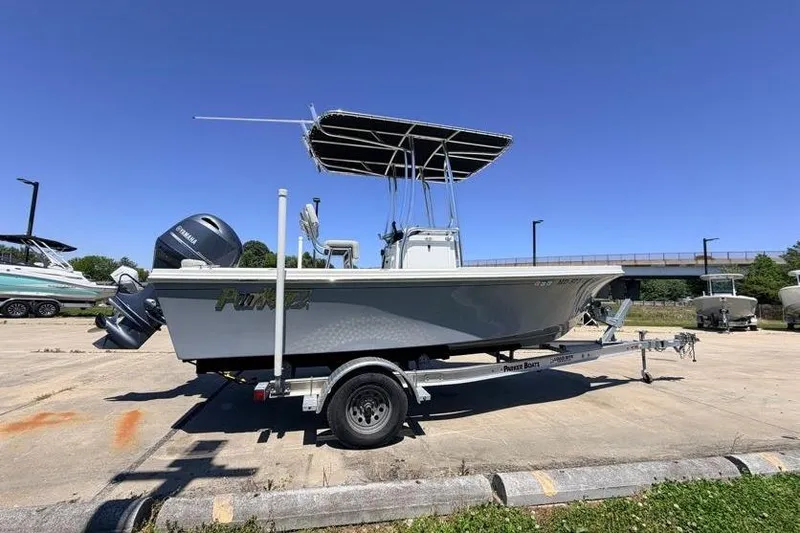 Slide: The Image of 2022 Parker 1801 Center Console boat on trailer, parked outdoors under clear blue sky. - 4