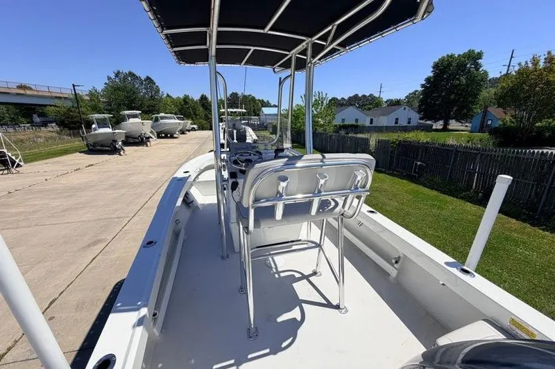 Slide: The Image of 2022 Parker 1801 Center Console boat with T-top, parked outdoors on a sunny day. - 7