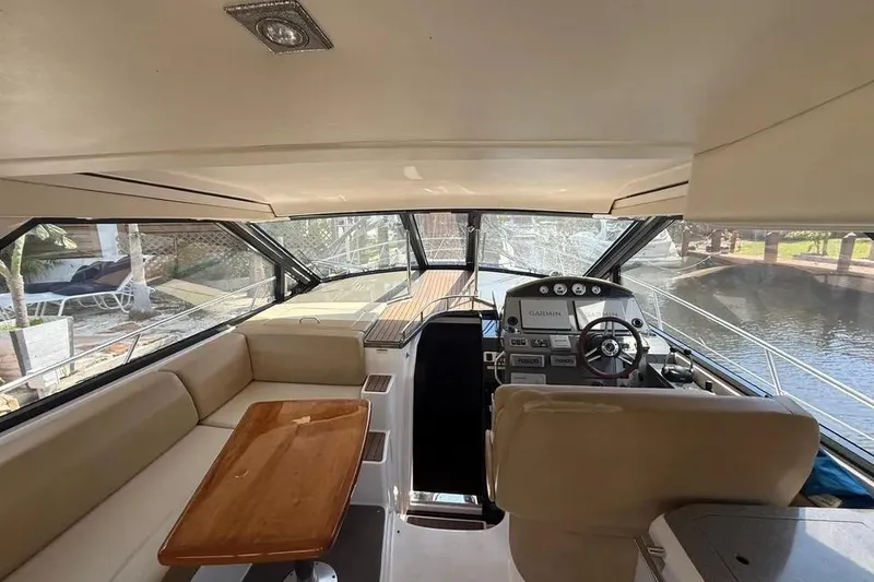 Slide: The Image of Interior view of 2011 Regal 46 Sport Coupe yacht cockpit with seating and helm. - 10