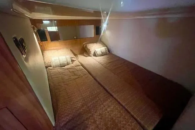 Slide: The Image of Twin beds in the cozy cabin of a 2011 Regal 46 Sport Coupe yacht. - 11