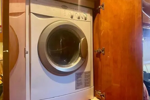 Slide: The Image of Washing machine inside a wooden cabinet on a 2011 Regal 46 Sport Coupe yacht. - 16