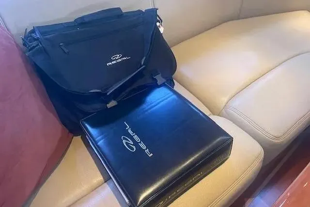 Slide: The Image of Black Regal bag and folder on beige leather seat, 2011 Regal 46 Sport Coupe. - 17