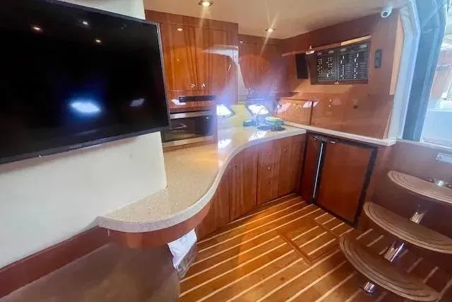 Slide: The Image of Luxurious interior of 2011 Regal 46 Sport Coupe yacht with modern kitchen amenities. - 19
