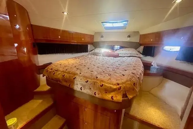 Slide: The Image of Luxurious cabin interior of 2011 Regal 46 Sport Coupe with cozy bed and wooden accents. - 22