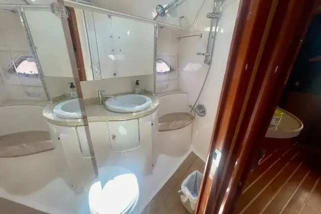 Slide: The Image of Luxurious bathroom in 2011 Regal 46 Sport Coupe yacht with dual sinks and modern fixtures. - 23