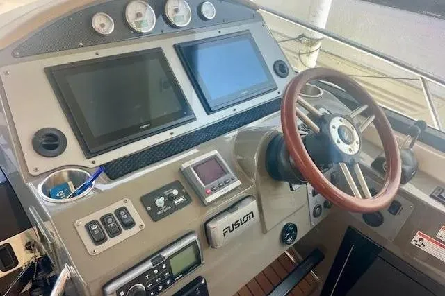 Slide: The Image of Dashboard of a 2011 Regal 46 Sport Coupe with navigation screens and controls. - 25