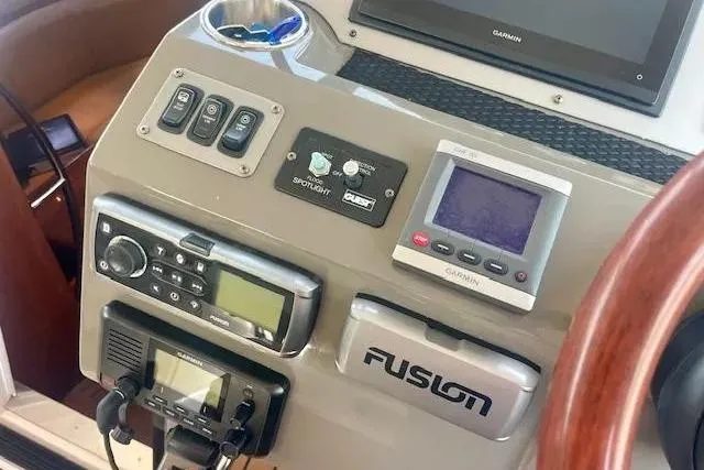 Slide: The Image of Control panel of a 2011 Regal 46 Sport Coupe with navigation and audio systems. - 27