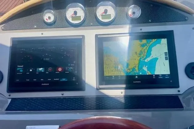 Slide: The Image of Dashboard of a 2011 Regal 46 Sport Coupe with Garmin navigation displays. - 30