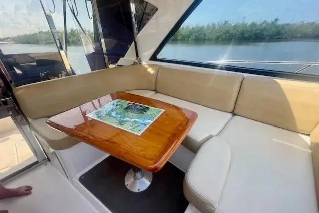 Slide: The Image of Interior of 2011 Regal 46 Sport Coupe with beige seating and wooden table. - 35