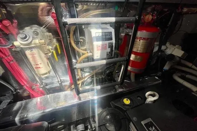 Slide: The Image of Engine room of a 2011 Regal 46 Sport Coupe with visible fire extinguisher and machinery. - 44