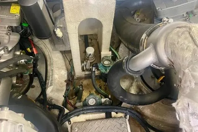 Slide: The Image of Engine compartment of a 2011 Regal 46 Sport Coupe with visible hoses and components. - 47