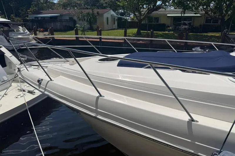 Slide: The Image of 2011 Regal 46 Sport Coupe yacht docked, featuring sleek design and covered deck. - 5