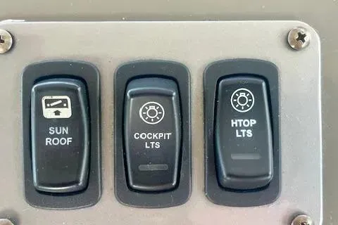 Slide: The Image of Control panel of a 2011 Regal 46 Sport Coupe with sunroof and light switches. - 50