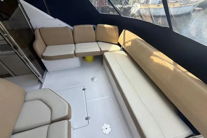 Slide: The Image of Interior seating area of 2011 Regal 46 Sport Coupe yacht with beige cushions. - 7