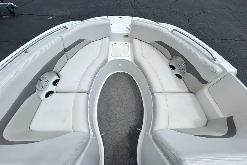 Slide: The Image of 2006 Chaparral Sunesta 274 boat interior with white seating and cup holders. - 3