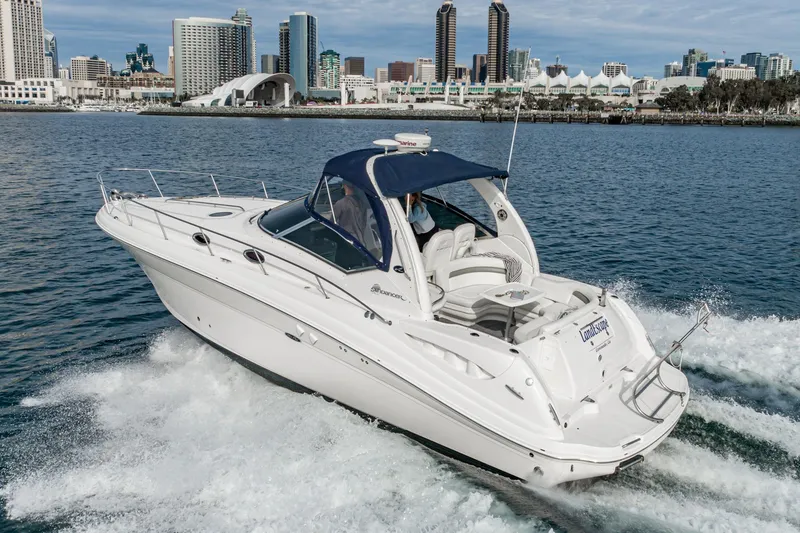 The Image of 2007 Sea Ray 340 Sundancer cruising near city skyline on calm waters. - 0