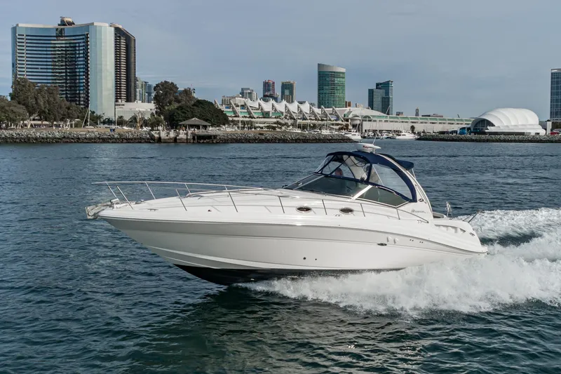 Slide: The Image of 2007 Sea Ray 340 Sundancer cruising near city skyline on a sunny day. - 11