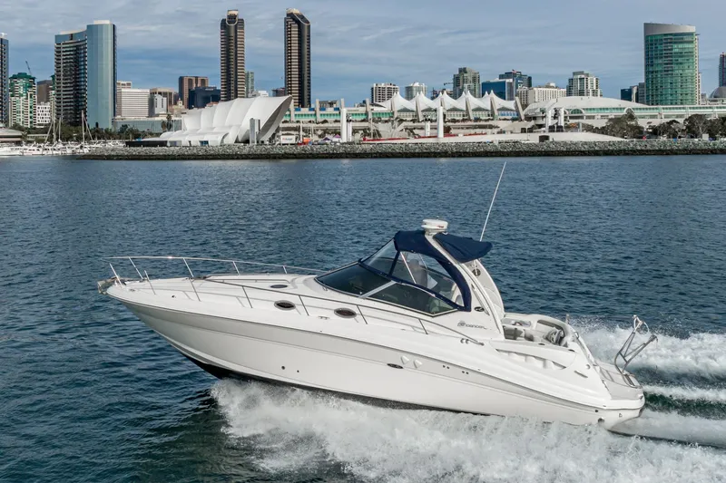 Slide: The Image of 2007 Sea Ray 340 Sundancer cruising near a city skyline on a sunny day. - 12