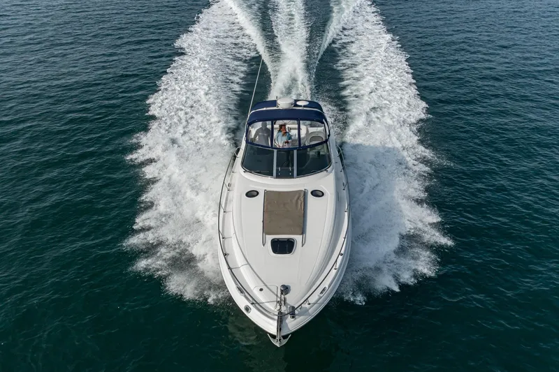Slide: The Image of 2007 Sea Ray 340 Sundancer cruising on open water, creating a dynamic wake. - 13