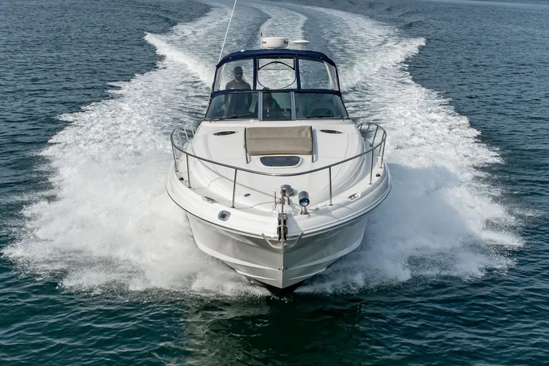 Slide: The Image of 2007 Sea Ray 340 Sundancer cruising on open water, creating a dynamic wake. - 14