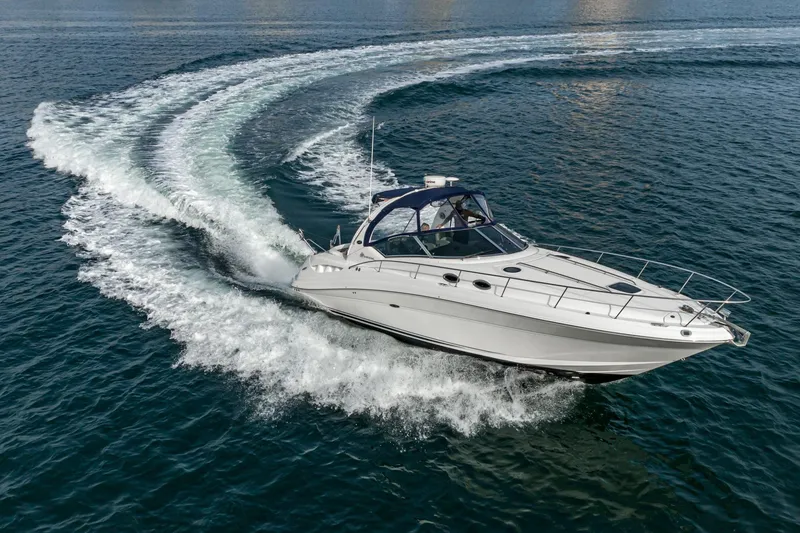 Slide: The Image of 2007 Sea Ray 340 Sundancer cruising on open water, creating a dynamic wake. - 16