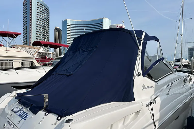Slide: The Image of 2007 Sea Ray 340 Sundancer yacht docked in marina with city skyline backdrop. - 2