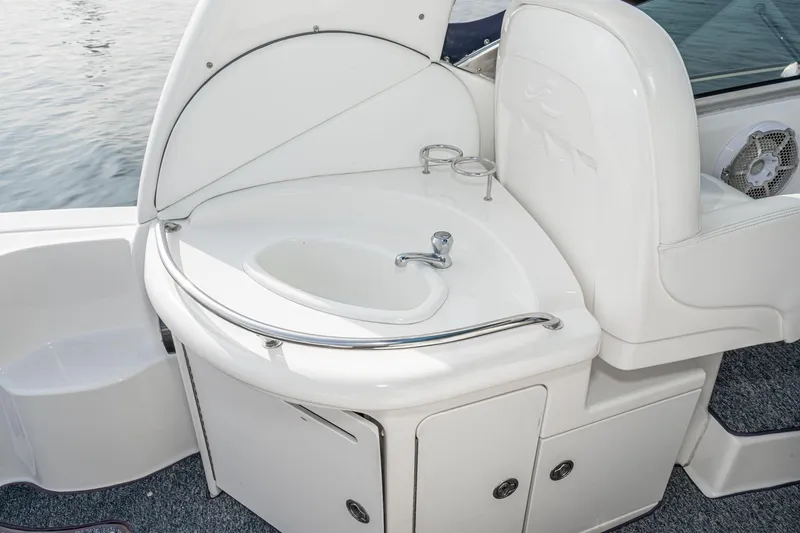 Slide: The Image of 2007 Sea Ray 340 Sundancer boat sink and seating area, featuring sleek white design. - 20
