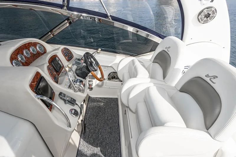 Slide: The Image of 2007 Sea Ray 340 Sundancer helm with luxurious white seating and advanced controls. - 23